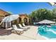 An amazing backyard features a sparkling pool and lounge chairs, perfect for outdoor relaxation and fun at 6391 Tempting Choice Ave, Las Vegas, NV 89131