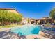 Large backyard pool with spa, mature trees, and patio seating at 6391 Tempting Choice Ave, Las Vegas, NV 89131