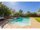Sparkling pool area surrounded by mature trees and a manicured lawn at 6391 Tempting Choice Ave, Las Vegas, NV 89131