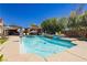 Inviting backyard pool features in-water seating and a stylish patio for relaxing and entertaining at 6391 Tempting Choice Ave, Las Vegas, NV 89131