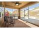 Inviting screened porch featuring a table, chairs, and views of the backyard at 6391 Tempting Choice Ave, Las Vegas, NV 89131
