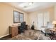 Bedroom with desk, chair, guitar, and window with plantation shutters at 6629 Breakwater Reef St, Las Vegas, NV 89149