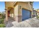 Exterior view of the garage with stone accents and a paved driveway leading to the charming front door at 6629 Breakwater Reef St, Las Vegas, NV 89149