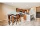 Bright kitchen with granite counters and stainless appliances, adjacent to a dining area with seating for four at 6629 Breakwater Reef St, Las Vegas, NV 89149