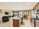 Open concept kitchen featuring granite counters, stainless appliances, and a breakfast bar adjoining the living area at 6629 Breakwater Reef St, Las Vegas, NV 89149