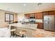 Modern kitchen with granite countertops, stainless steel appliances, and a central island with seating at 6629 Breakwater Reef St, Las Vegas, NV 89149