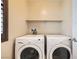 Bright laundry room has a pair of new, white, front-loading machines at 6629 Breakwater Reef St, Las Vegas, NV 89149