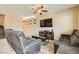 Bright living room with tile floors, comfortable seating, and a modern entertainment center at 6629 Breakwater Reef St, Las Vegas, NV 89149