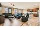 Spacious living room featuring hardwood floors, a ceiling fan, and large windows for natural light at 6629 Breakwater Reef St, Las Vegas, NV 89149