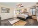 Comfortable carpeted main bedroom with a ceiling fan, neutral decor, and an ensuite bathroom entrance at 6629 Breakwater Reef St, Las Vegas, NV 89149