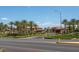 Community entrance featuring landscaping and palm trees at 6959 Emerald Springs Ln, Las Vegas, NV 89113