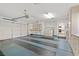 Spacious garage featuring washer, dryer, shelving, and storage cabinets at 6959 Emerald Springs Ln, Las Vegas, NV 89113