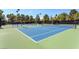 Well-maintained tennis courts are surrounded by mature trees, providing shade and privacy at 6959 Emerald Springs Ln, Las Vegas, NV 89113