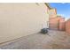 This gravel backyard has plenty of room, with a block wall dividing properties at 6989 Walden Park St, Las Vegas, NV 89166