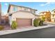 A two-story home showcases a two-car garage and well-maintained front yard at 6989 Walden Park St, Las Vegas, NV 89166