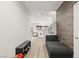 Hallway leading to the living room, with wood-like floors and a seating area at 6989 Walden Park St, Las Vegas, NV 89166