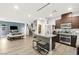 Spacious open-concept kitchen with an island seamlessly connects to the living room and staircase at 6989 Walden Park St, Las Vegas, NV 89166