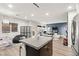 Open-concept kitchen with granite island overlooking the living area, perfect for gatherings at 6989 Walden Park St, Las Vegas, NV 89166