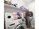 Well-lit laundry room with modern, front-loading machines and lots of storage space at 6989 Walden Park St, Las Vegas, NV 89166