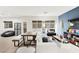 Bright living room with hardwood floors, a fireplace, and a dining table by the sofa at 6989 Walden Park St, Las Vegas, NV 89166