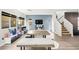 Bright living room with hardwood floors, a fireplace, and a dining table by the sofa at 6989 Walden Park St, Las Vegas, NV 89166