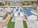 Aerial view of a two-story home with solar panels, a well-maintained lawn, and a two-car garage at 7020 English Mist Cir, Las Vegas, NV 89128