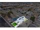 Aerial view of a two-story home with solar panels and a well-maintained lawn at 7020 English Mist Cir, Las Vegas, NV 89128