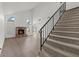 Bright living room with fireplace, stairs, and new flooring at 7020 English Mist Cir, Las Vegas, NV 89128