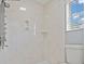 Updated shower with sleek marble-style wall surround and modern fixtures at 7020 English Mist Cir, Las Vegas, NV 89128