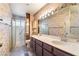 This bathroom features a double sink vanity with framed mirror and a separate shower stall at 706 Morrocco Dr, Henderson, NV 89002