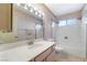 A bathroom features a double sink, large mirror, and shower-tub combo with white tile surround at 706 Morrocco Dr, Henderson, NV 89002