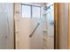 A white shower stall features built-in shelving and chrome grab bars at 706 Morrocco Dr, Henderson, NV 89002