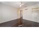 An empty bedroom features dark wood-look floors, wallpaper, a fan, and access to an attached bathroom at 706 Morrocco Dr, Henderson, NV 89002