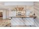 Well-lit kitchen featuring a breakfast bar, classic white cabinets, and modern appliances, offering style and functionality at 706 Morrocco Dr, Henderson, NV 89002