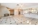 Bright living room with a fireplace, tiled floors, and an open layout that seamlessly connects to the kitchen at 706 Morrocco Dr, Henderson, NV 89002