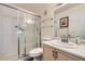 Bathroom featuring glass shower doors, a toilet, and a stylish vanity sink at 7632 Amato Ave, Las Vegas, NV 89128