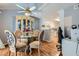 Cozy eat-in-kitchen nook with glass table, accented by contemporary chandelier and cabinets at 7632 Amato Ave, Las Vegas, NV 89128