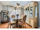 Dining room featuring hardwood floors, glass table and china cabinet at 7632 Amato Ave, Las Vegas, NV 89128