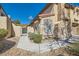 Property featuring a gated courtyard entrance with desert landscaping at 7632 Amato Ave, Las Vegas, NV 89128