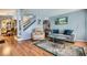 Living room features hardwood floors and neutral walls, with lots of seating and natural light at 7632 Amato Ave, Las Vegas, NV 89128