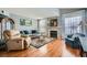 Cozy living room featuring hardwood floors, fireplace, and large windows with natural lighting at 7632 Amato Ave, Las Vegas, NV 89128