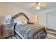 Bright bedroom featuring a ceiling fan, bedside lamps, decorative furniture, and wood flooring at 7632 Amato Ave, Las Vegas, NV 89128