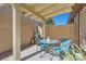 Cozy patio with teal furniture set underneath a wood pergola at 7632 Amato Ave, Las Vegas, NV 89128