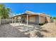 Cozy backyard patio area with cover, providing a comfortable outdoor living space with rock landscaping at 7719 Selby Ct, Las Vegas, NV 89147