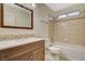 Bathroom featuring a vanity with drawers, toilet, and tiled shower-tub at 7719 Selby Ct, Las Vegas, NV 89147