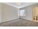 Cozy bedroom featuring carpeted floors, bright windows, and neutral paint at 7719 Selby Ct, Las Vegas, NV 89147