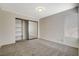 Bedroom featuring mirrored closet doors, carpeted floors, and natural lighting at 7719 Selby Ct, Las Vegas, NV 89147