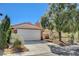 Charming home featuring a two-car garage, well-maintained lawn, and mature landscaping at 7719 Selby Ct, Las Vegas, NV 89147