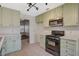 Kitchen with stainless steel microwave and black oven, leading to living area at 7719 Selby Ct, Las Vegas, NV 89147