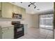 Kitchen with stainless steel microwave, black oven, and sliding doors to fenced-in yard at 7719 Selby Ct, Las Vegas, NV 89147